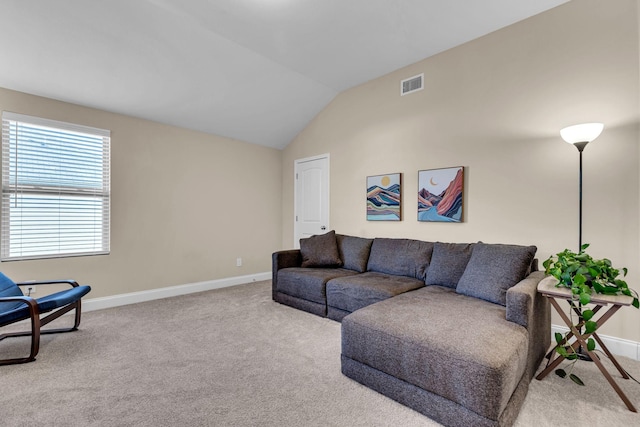 living room with lofted ceiling, carpet floors, visible vents, and baseboards