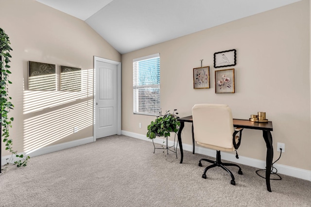 carpeted office with lofted ceiling and baseboards