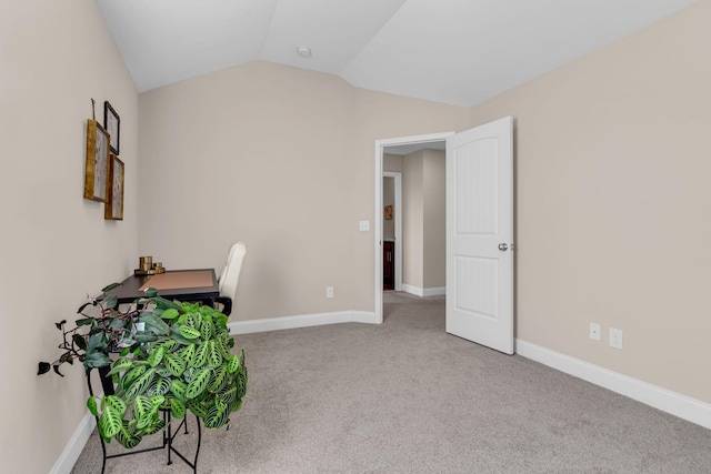 office with carpet, lofted ceiling, and baseboards