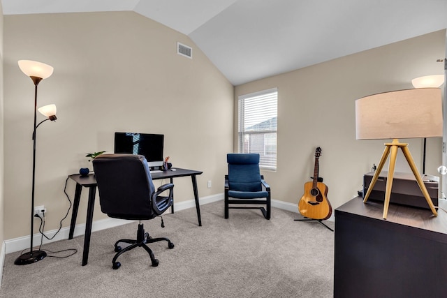 carpeted home office with lofted ceiling, baseboards, and visible vents