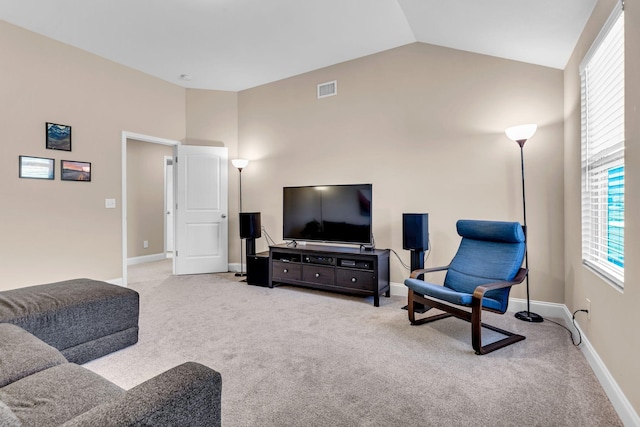 living area with high vaulted ceiling, baseboards, visible vents, and carpet flooring