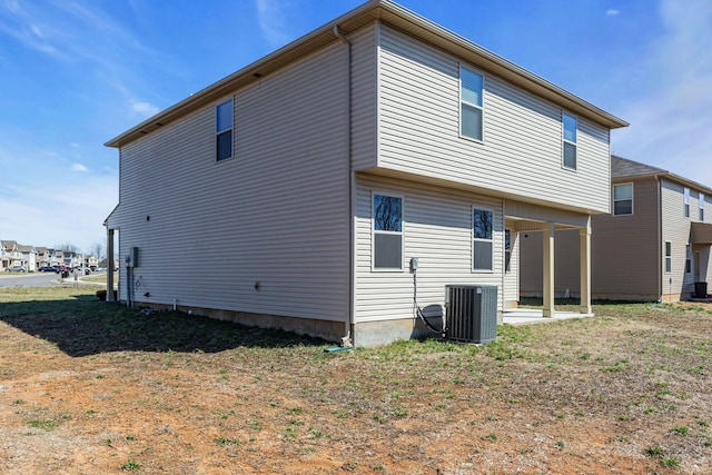 rear view of house with central AC