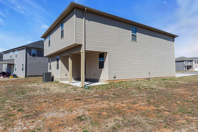 rear view of property featuring central AC and a patio