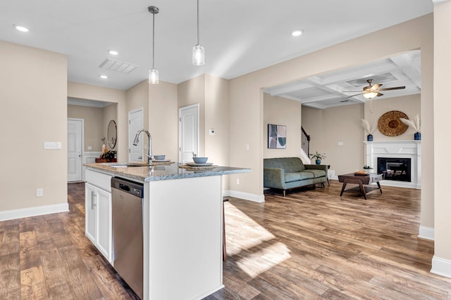 kitchen featuring coffered ceiling, wood finished floors, stainless steel dishwasher, a fireplace, and a sink