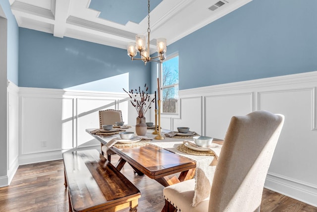 dining area with a decorative wall, a notable chandelier, dark wood-style flooring, visible vents, and beamed ceiling