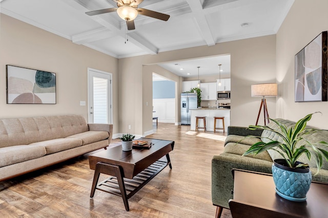 living room featuring beam ceiling, coffered ceiling, and light wood-style flooring