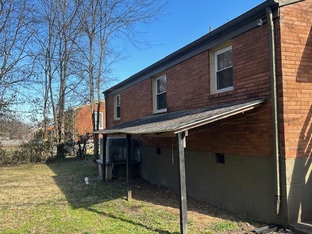 view of home's exterior with a lawn