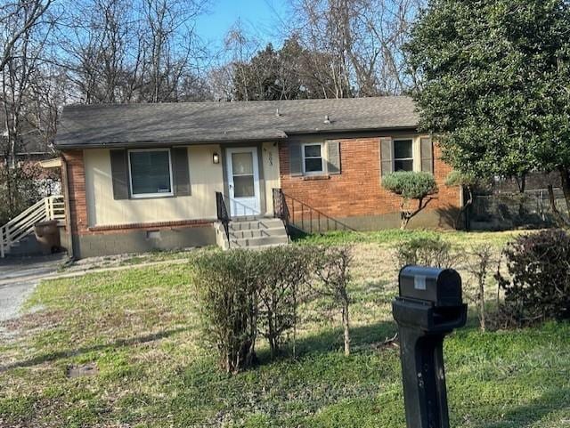 single story home featuring entry steps, crawl space, brick siding, and a front lawn