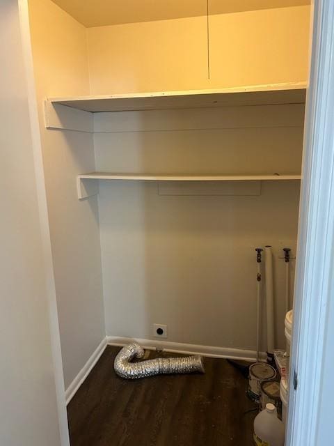 laundry room with baseboards, laundry area, dark wood finished floors, and hookup for an electric dryer