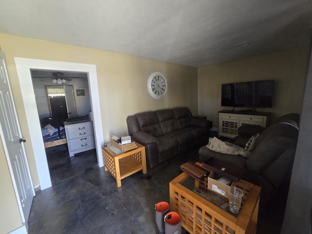 living area featuring ceiling fan and finished concrete flooring