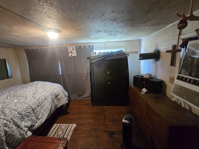 bedroom with a textured ceiling and wood finished floors