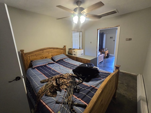 bedroom featuring a baseboard heating unit, ceiling fan, visible vents, and baseboards