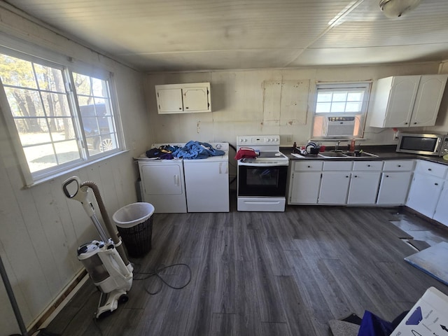 kitchen with white electric stove, a sink, independent washer and dryer, stainless steel microwave, and dark countertops