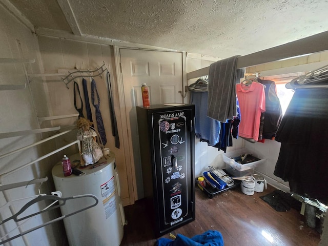 spacious closet with water heater and wood finished floors