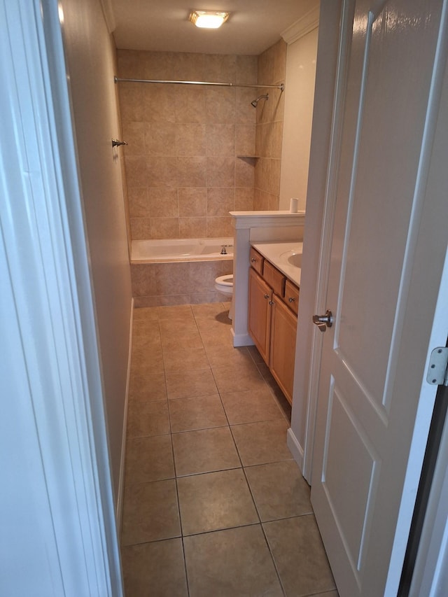 full bath with toilet, tiled shower / bath combo, vanity, and tile patterned floors