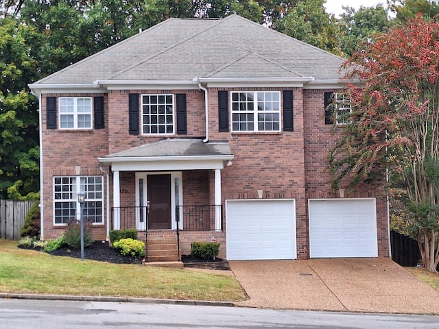 view of front of house with a porch, concrete driveway, brick siding, and a garage