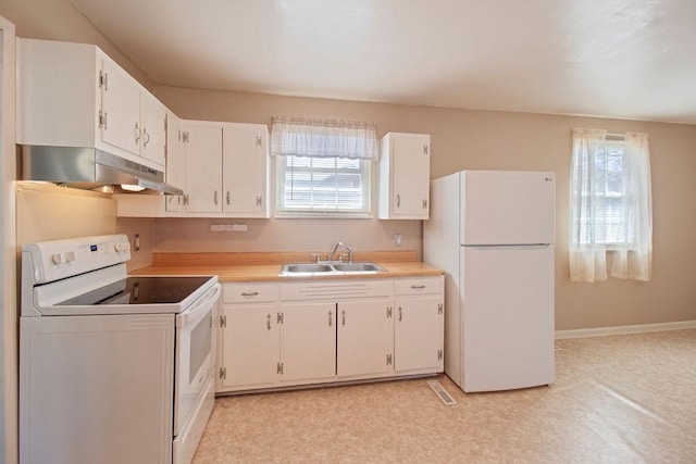 kitchen featuring white appliances, white cabinetry, a sink, and under cabinet range hood