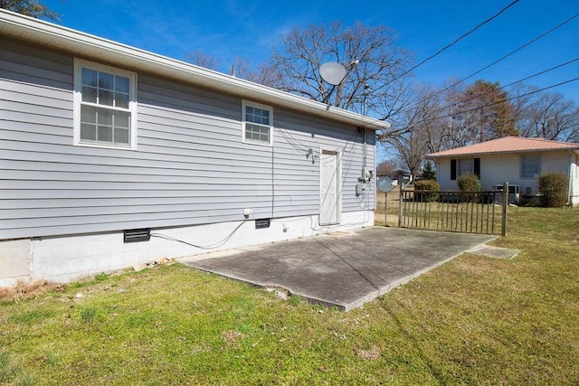 back of house featuring a patio, crawl space, and a lawn