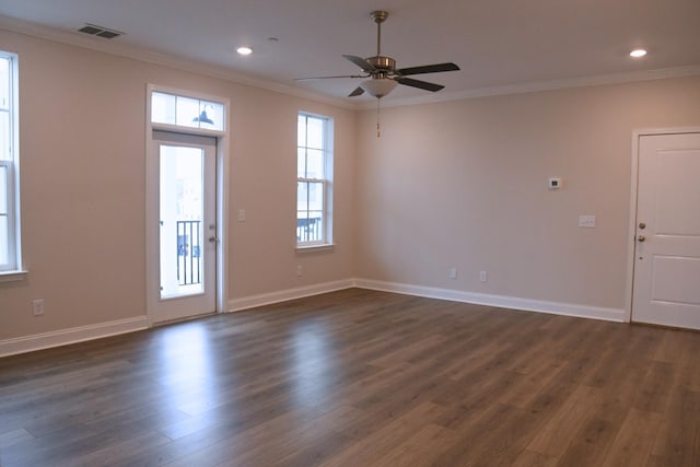 entrance foyer with dark wood-style floors, baseboards, visible vents, and crown molding