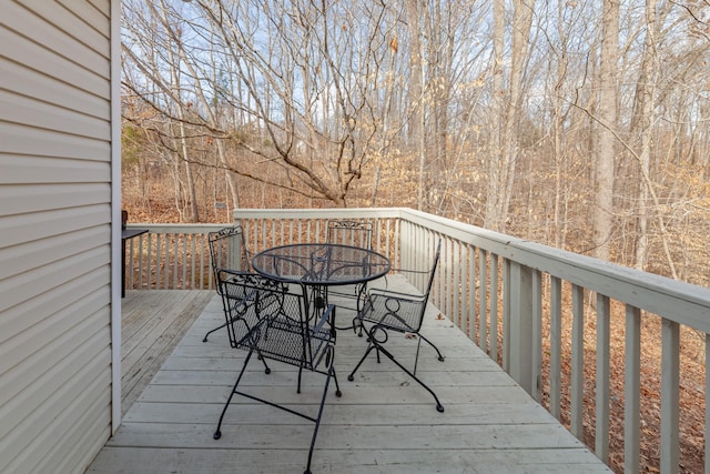 wooden terrace featuring outdoor dining space