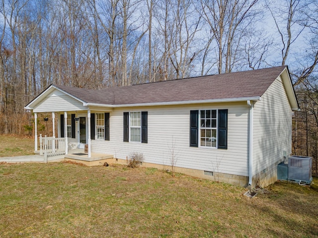 ranch-style home with a porch, a shingled roof, crawl space, central AC, and a front lawn