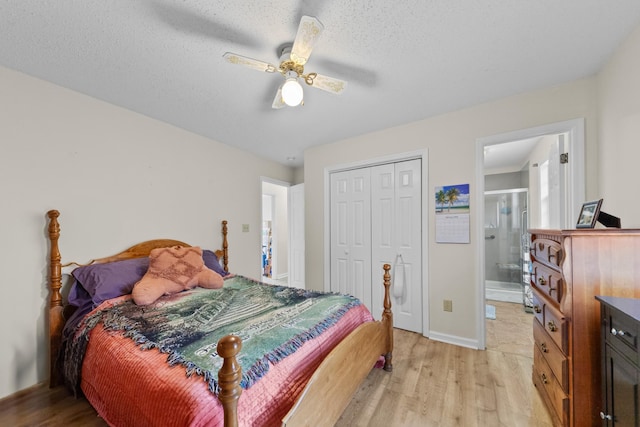 bedroom with light wood-type flooring, a closet, and a textured ceiling