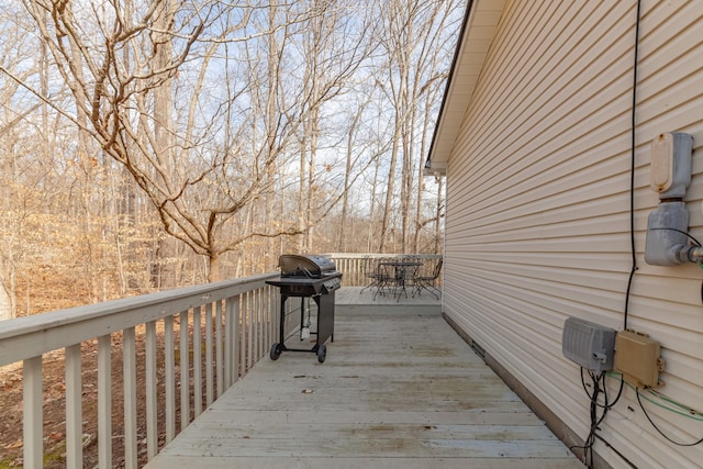 deck with grilling area and outdoor dining space