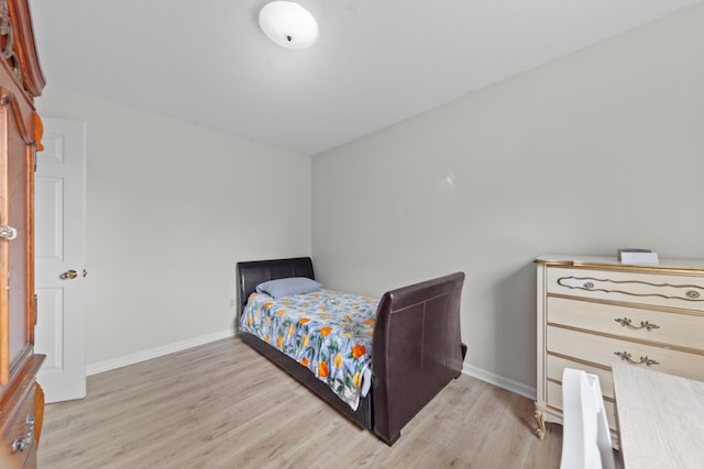 bedroom with light wood-style floors and baseboards