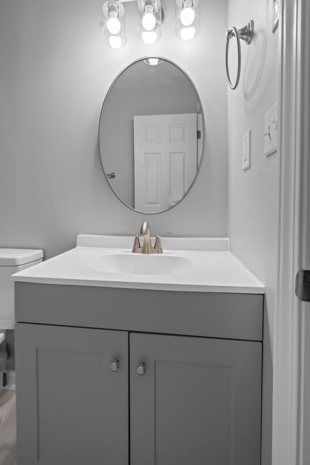 half bathroom with toilet and vanity