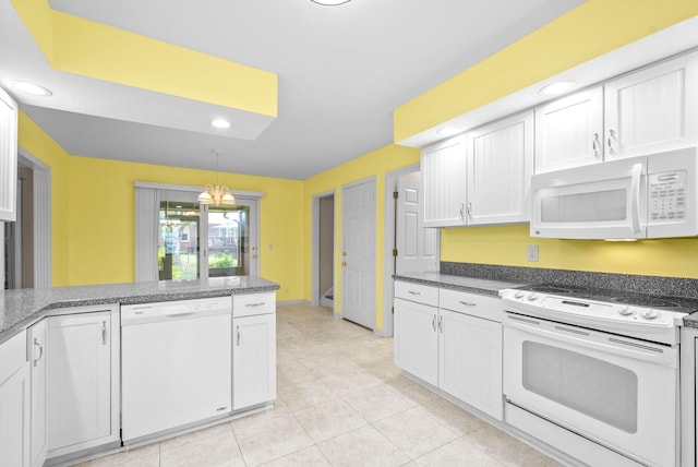 kitchen featuring recessed lighting, white appliances, white cabinetry, and decorative light fixtures