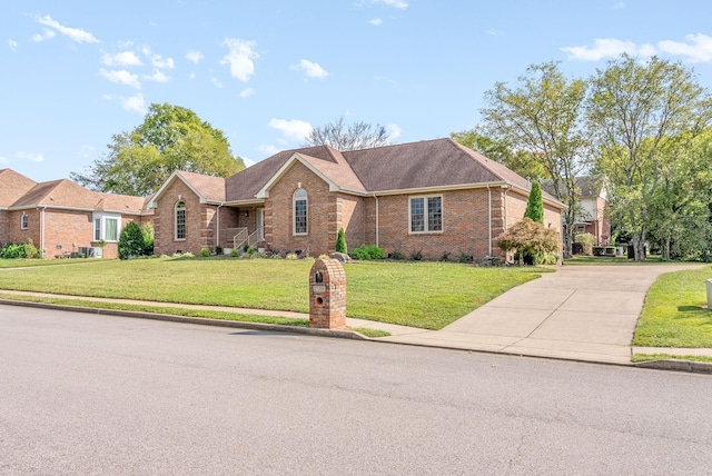 single story home with a front lawn, concrete driveway, and brick siding