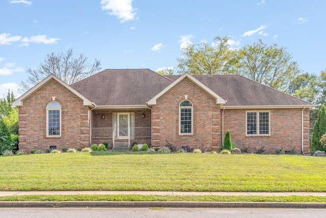 ranch-style home featuring roof with shingles, brick siding, crawl space, and a front yard