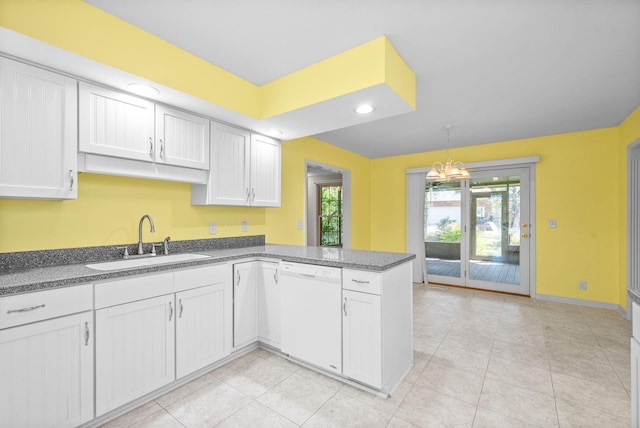 kitchen featuring a peninsula, a sink, white cabinets, dishwasher, and pendant lighting