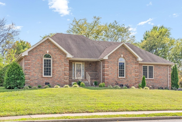 ranch-style house featuring crawl space, a shingled roof, a front lawn, and brick siding