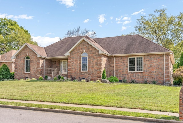 single story home with a shingled roof, brick siding, and a front lawn