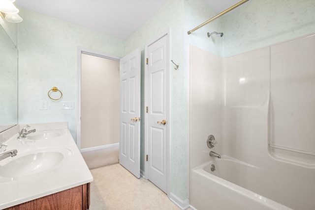 full bath with double vanity, tub / shower combination, and a sink