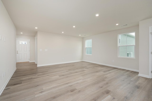 empty room with recessed lighting, visible vents, baseboards, and light wood-style floors