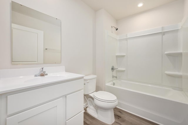 bathroom with toilet, vanity, shower / bathing tub combination, and wood finished floors