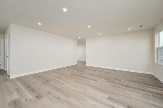 spare room featuring recessed lighting, light wood-type flooring, baseboards, and visible vents