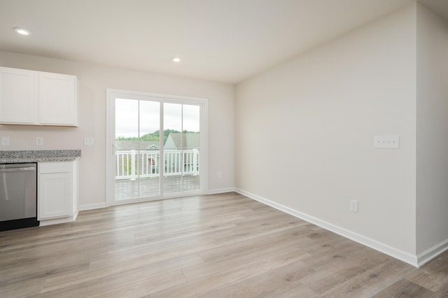 unfurnished living room with recessed lighting, baseboards, and light wood-style flooring