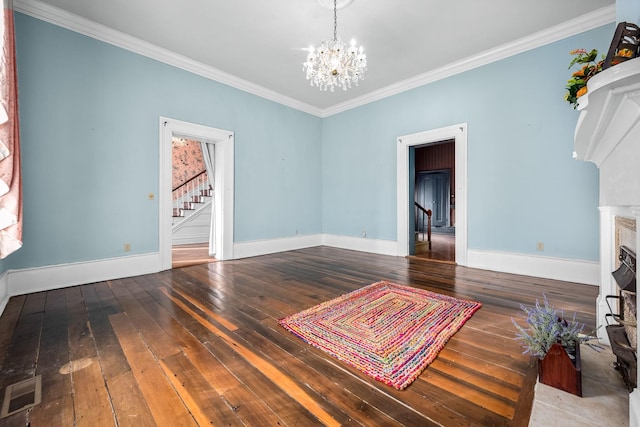 living area featuring visible vents, hardwood / wood-style flooring, a fireplace with flush hearth, ornamental molding, and a notable chandelier