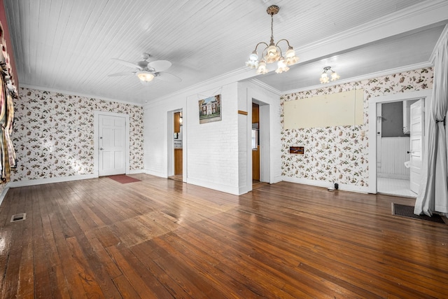 empty room featuring crown molding, visible vents, and hardwood / wood-style floors