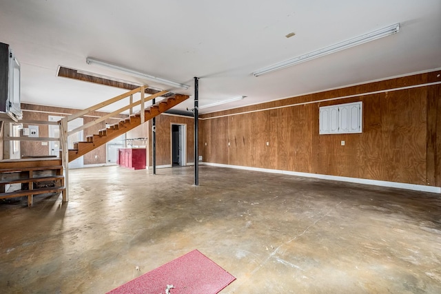 garage with wood walls and baseboards