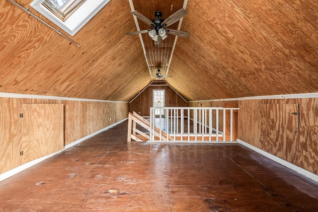 additional living space featuring vaulted ceiling with skylight, wood ceiling, wooden walls, and hardwood / wood-style floors