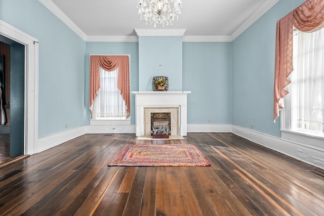 unfurnished living room with a high end fireplace, hardwood / wood-style flooring, plenty of natural light, and an inviting chandelier