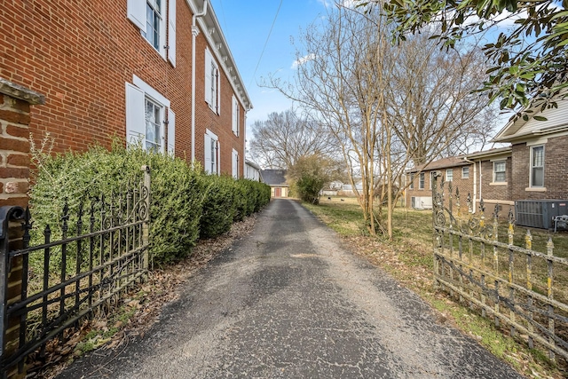 view of road featuring aphalt driveway and a gated entry