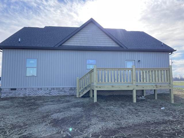 back of property featuring a shingled roof, crawl space, and a deck