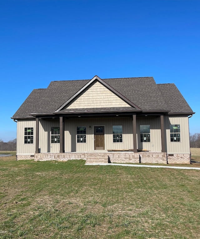 view of front of house featuring roof with shingles, a front lawn, crawl space, and board and batten siding