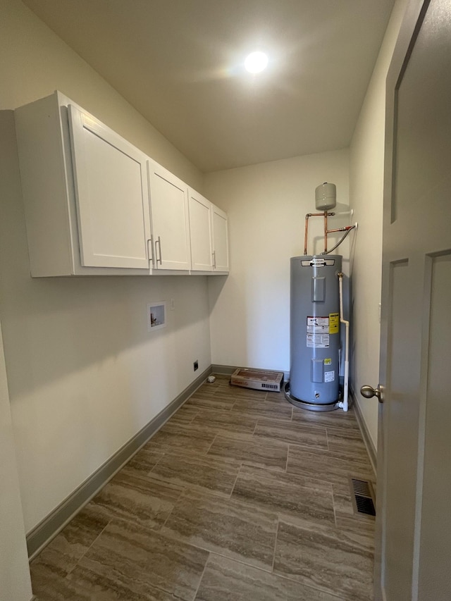 laundry room featuring visible vents, electric water heater, electric dryer hookup, baseboards, and hookup for a washing machine