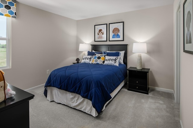 carpeted bedroom featuring baseboards